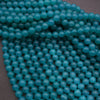Close-up of a string of blue beads on a dark background