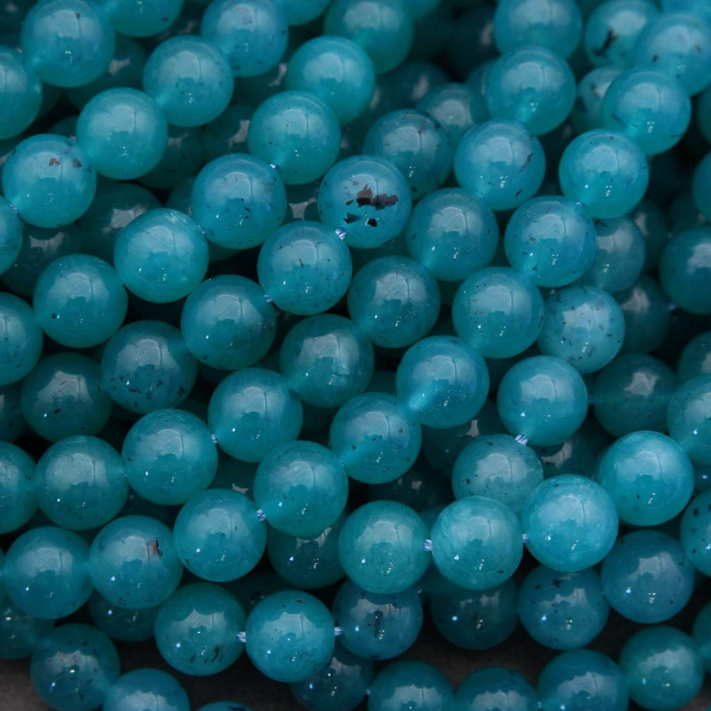 Close-up of teal beads with a dark background