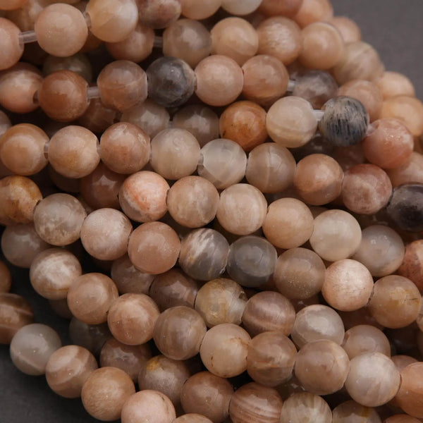 Close-up of a string of brown and beige beads on a dark background