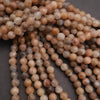 Close-up of a string of brown and beige beads on a dark background