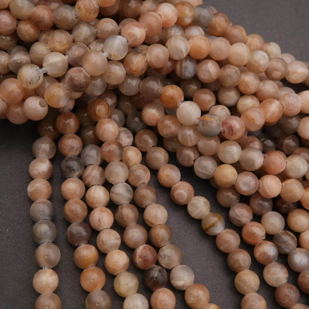 Close-up of a string of brown and beige beads on a dark background