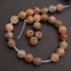 Beaded bracelet with brown and beige beads on a dark background