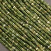 Close-up of green glass beads on a gray background