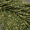 Close-up of green glass beads on a gray background