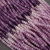 Close-up of purple and pink beads on a gray background