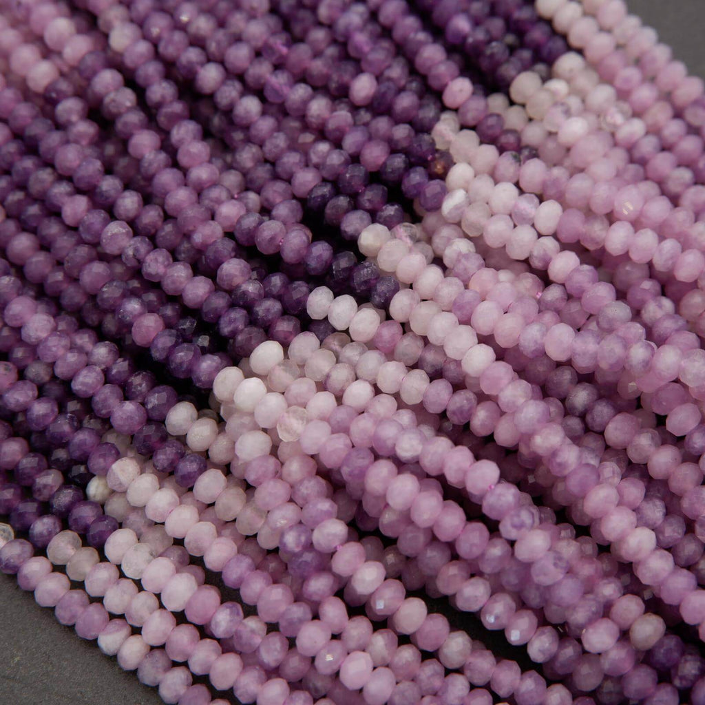 Close-up of purple and pink beads on a gray background