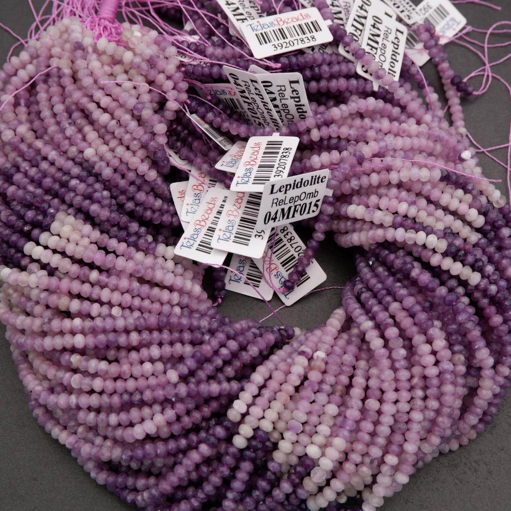 Close-up of purple and white beads with labels on a dark background