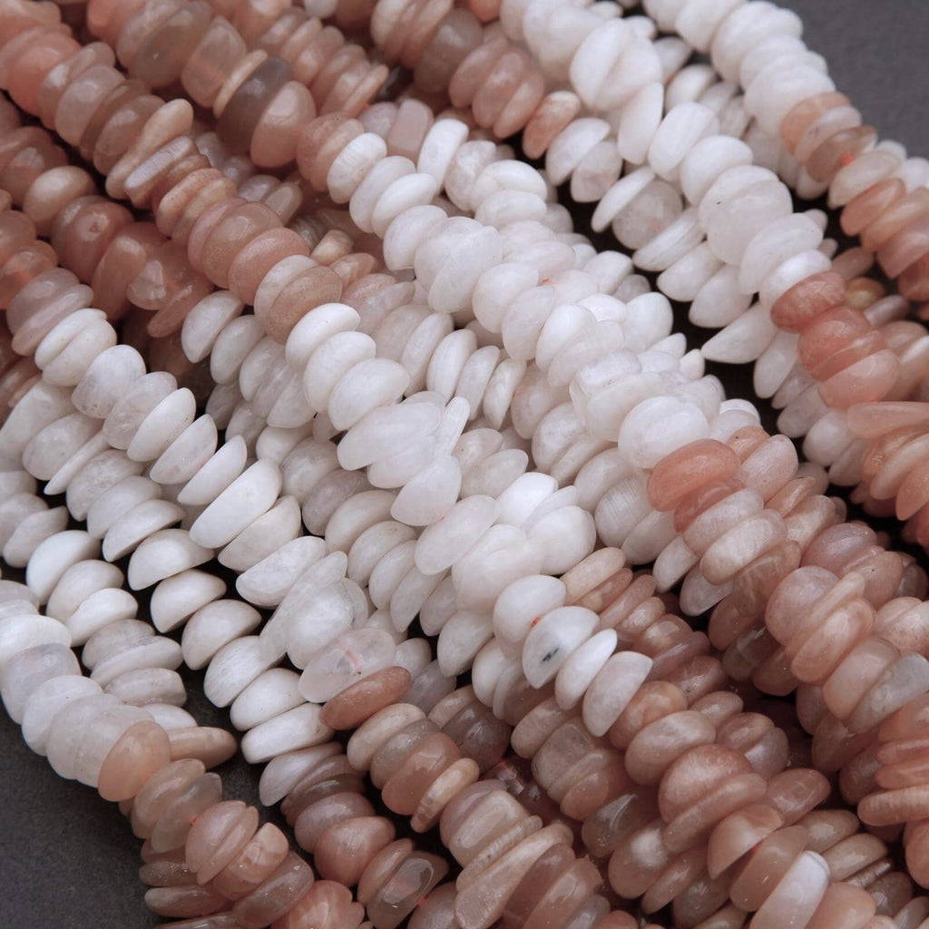 Close-up of pink and white stone beads on a dark background