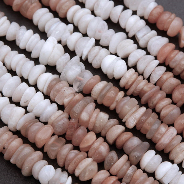 Close-up of a string of white and pink beads on a dark background