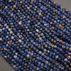 Close-up of blue and orange beads on a gray surface