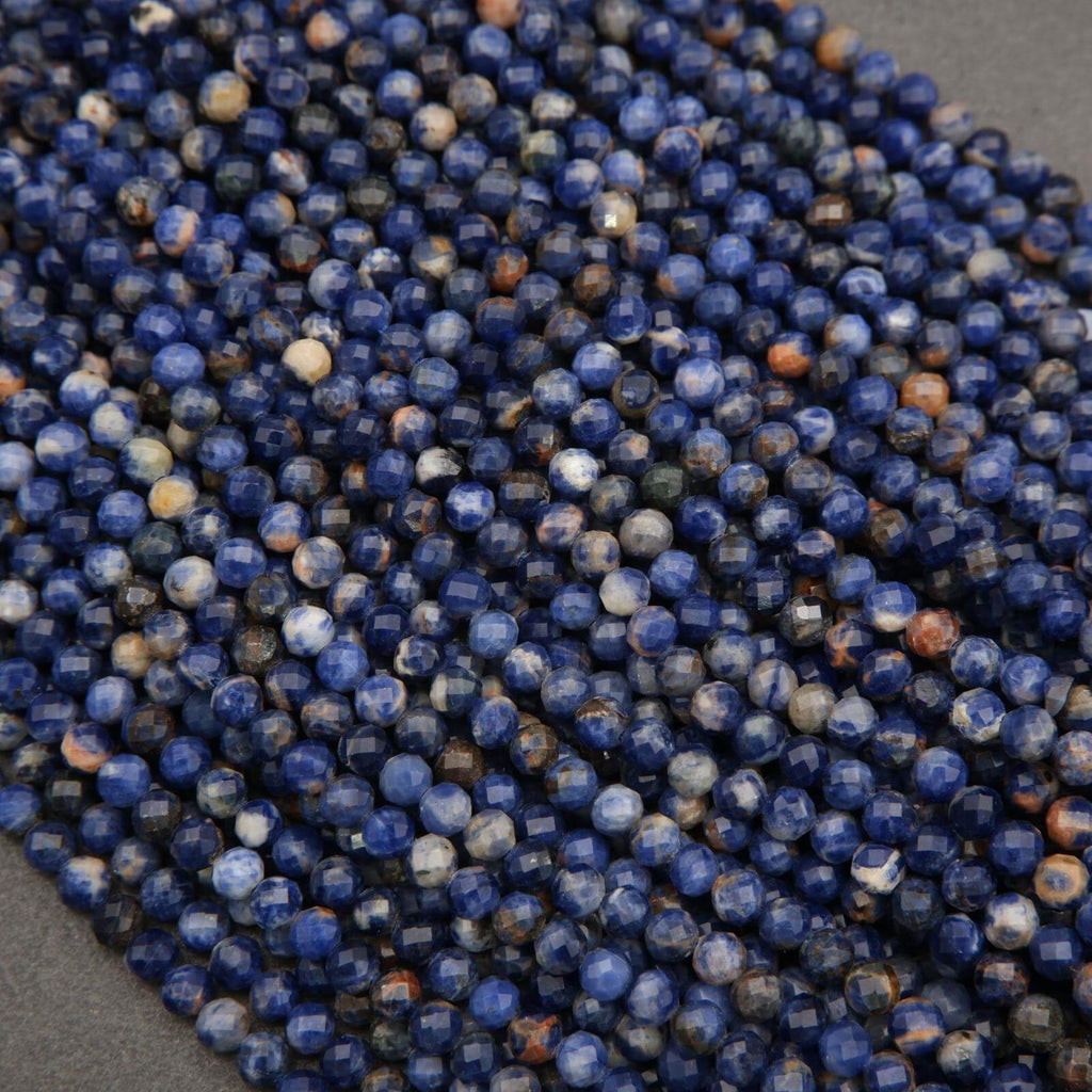 Close-up of blue and orange beads on a gray surface