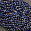 Close-up of blue faceted beads on a gray surface
