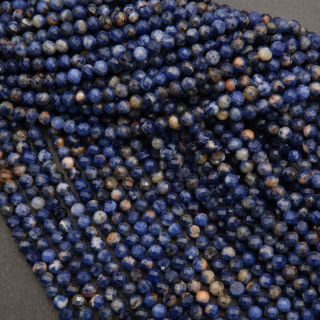 Close-up of blue and brown faceted beads on a dark surface