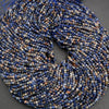 Orange, blue, and white, round faceted beads.