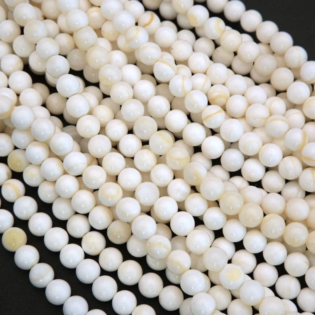 White Shell Beads with Yellow Highlights.