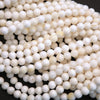 White Shell Beads with Yellow Highlights.