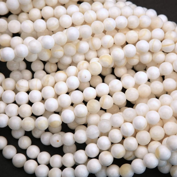 White Shell Beads with Yellow Highlights.