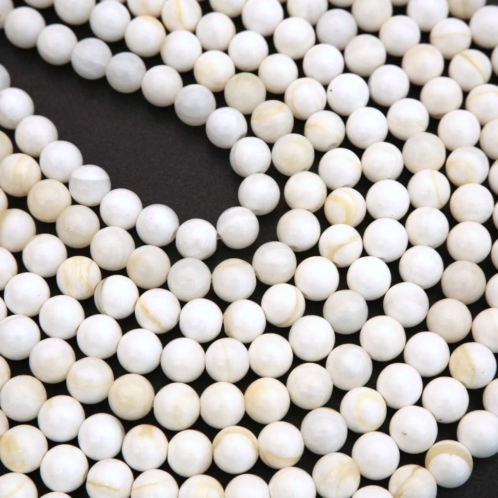 Close-up of white beads on a black background