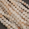 Close-up of a string of white and beige beads on a dark background