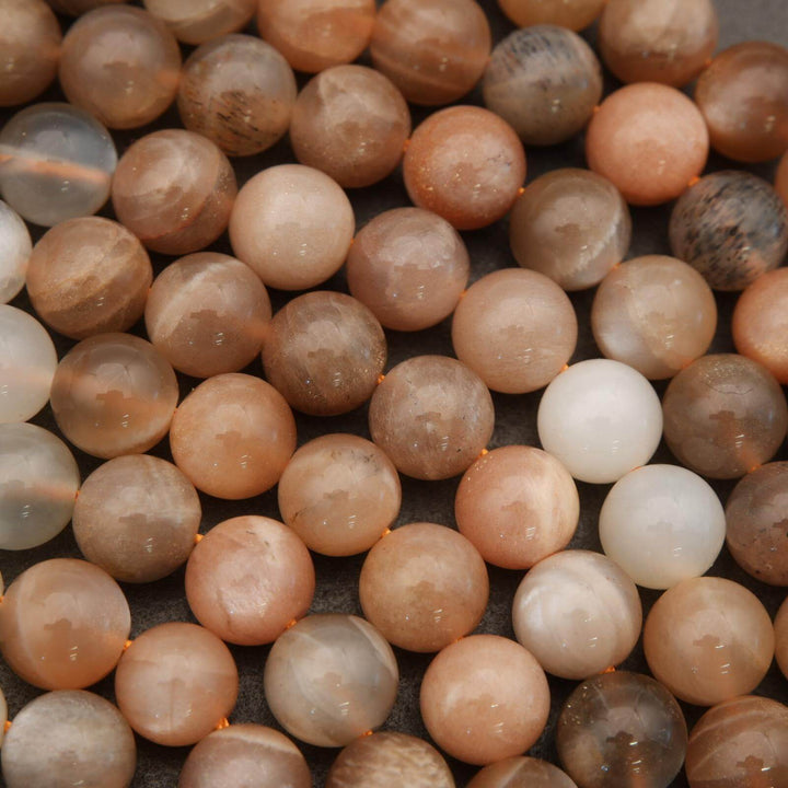 Close-up of multicolored round beads on a textured surface