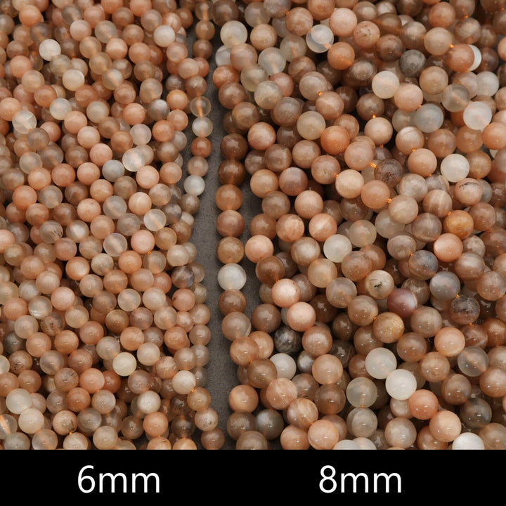 Close-up of two strands of round beads labeled '6mm' and '8mm'.