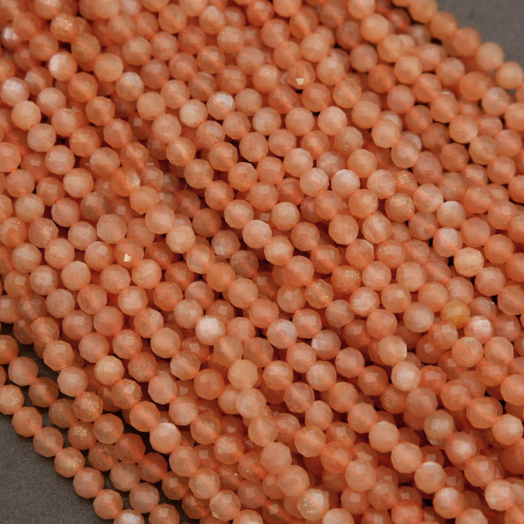 Close-up of pinkish-orange beads on a gray surface