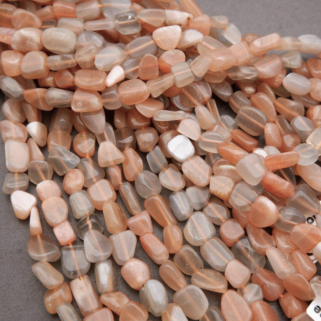 Close-up of pink and white stone beads on a gray surface