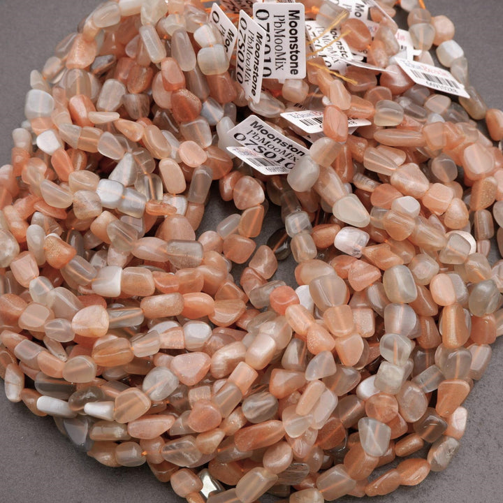 Necklace of small, multicolored stones with labels on a gray background