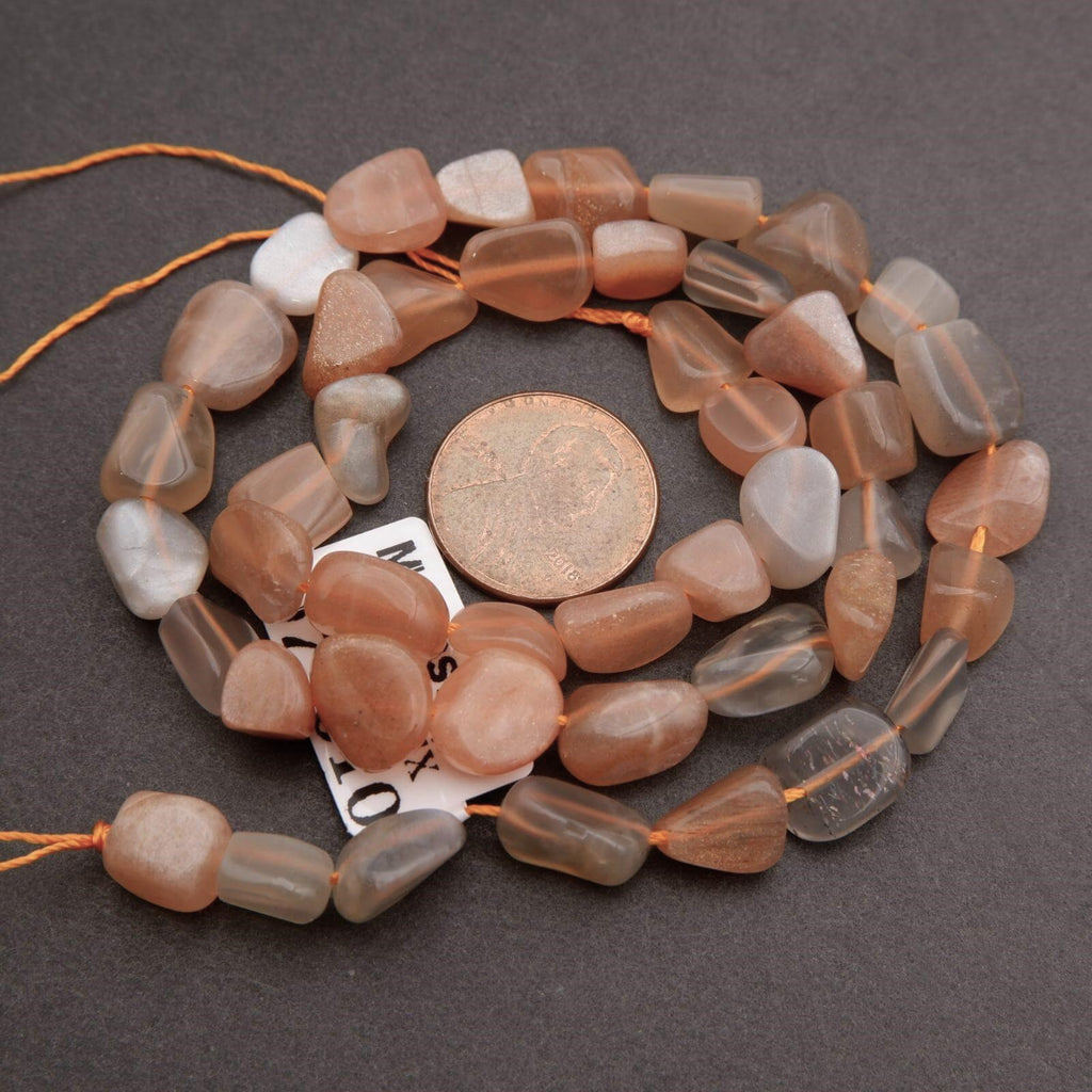 String of brown and gray beads with a coin for size comparison on a dark surface