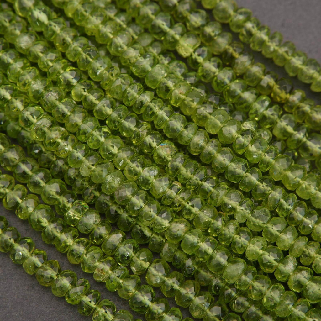 Close-up of green peridot beads on a dark background