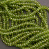 Close-up of green peridot beads on a dark background