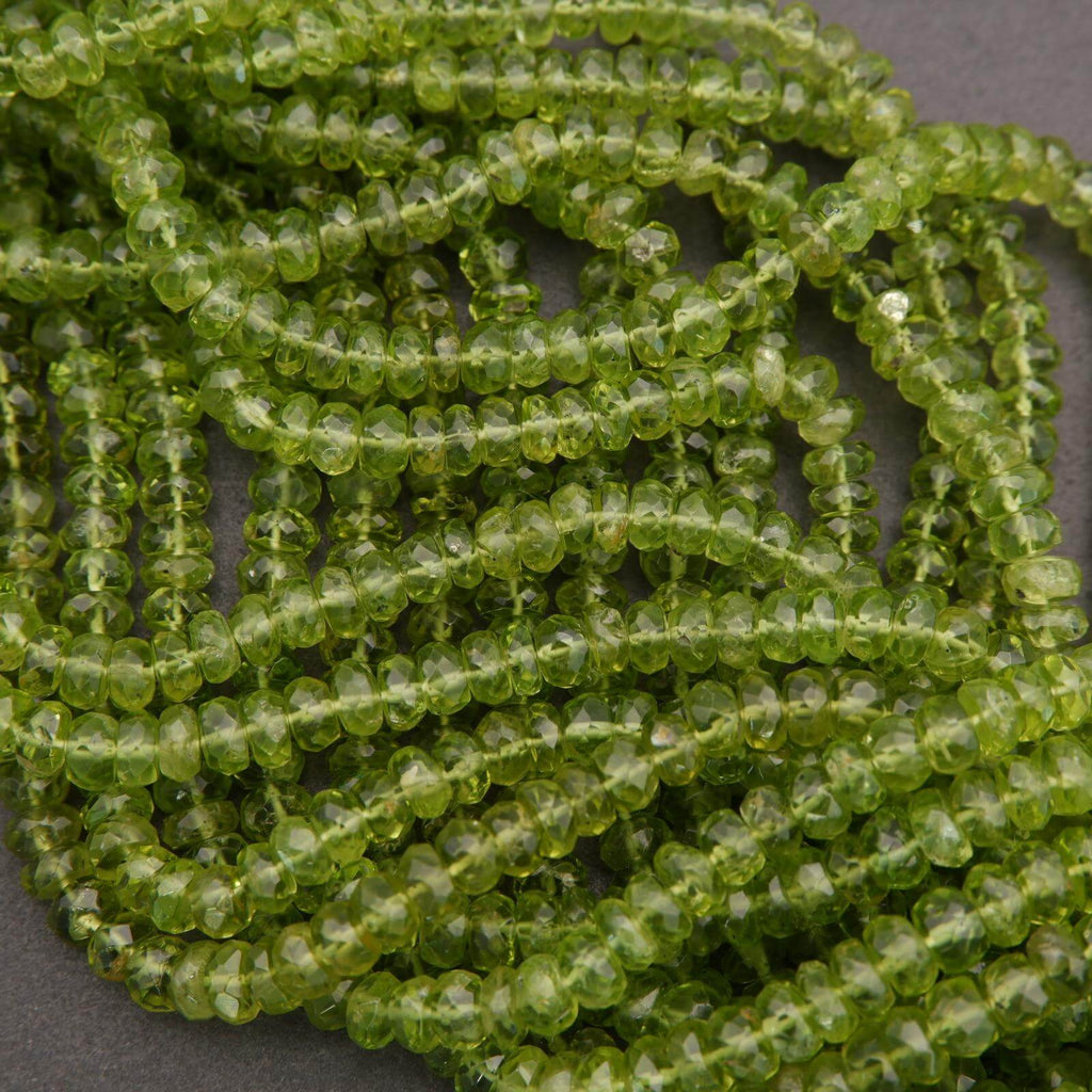Close-up of green peridot beads on a dark background