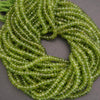 Green peridot beads on a gray background