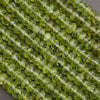 Close-up of green peridot beads on a gray background