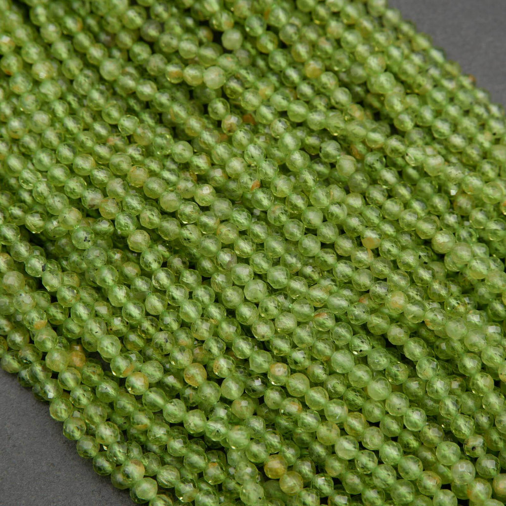 Green round faceted beads with yellow inclusions.