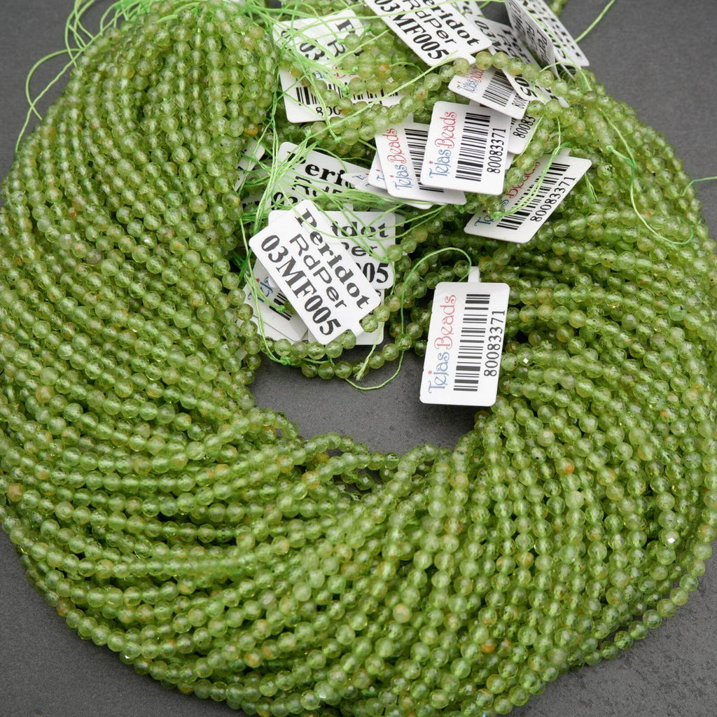 Green round faceted beads with yellow inclusions.
