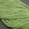 Close-up of a string of light green beads on a dark background