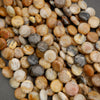 Detailed view of polished round stone beads with natural banding and earthy neutral colors.