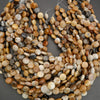 Macro image of polished gemstone beads highlighting natural textures and subtle patterning.