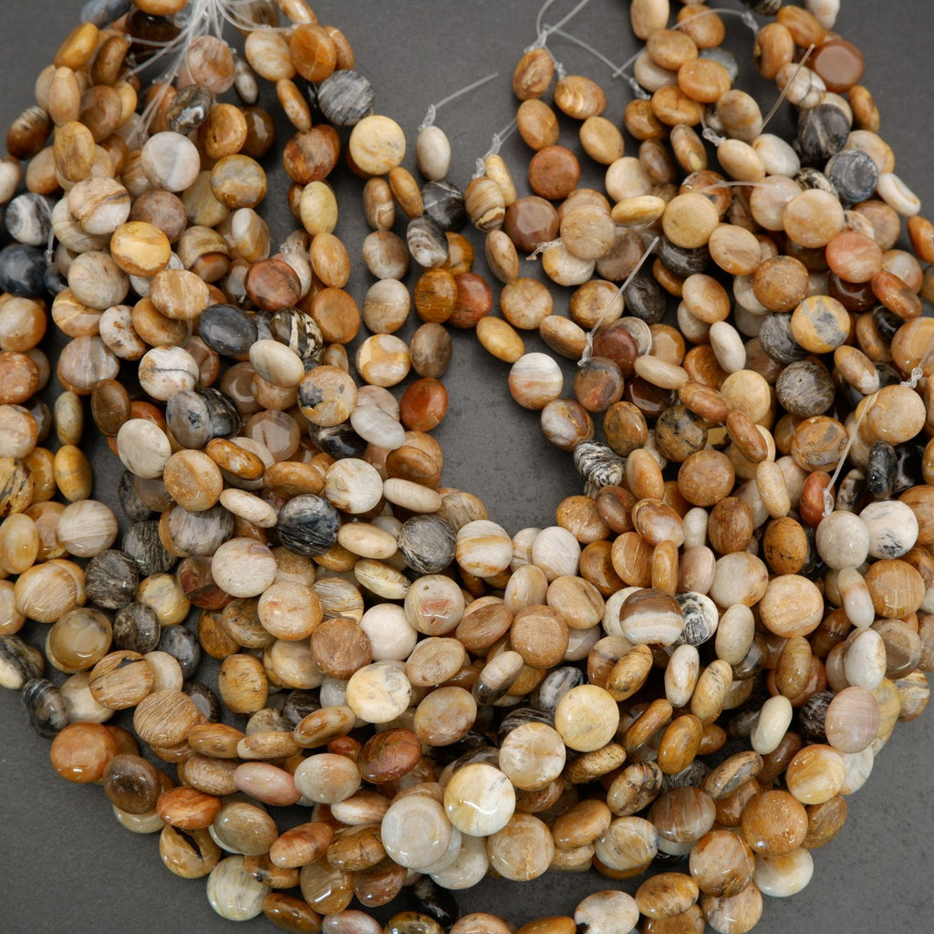 Macro image of polished gemstone beads highlighting natural textures and subtle patterning.