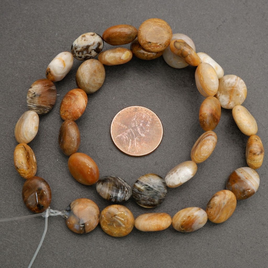 Natural stone round bead strand displayed with neutral tones and organic surface detail.