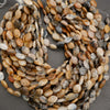 Macro image of marquise-shaped gemstone beads highlighting smooth finish and natural texture.