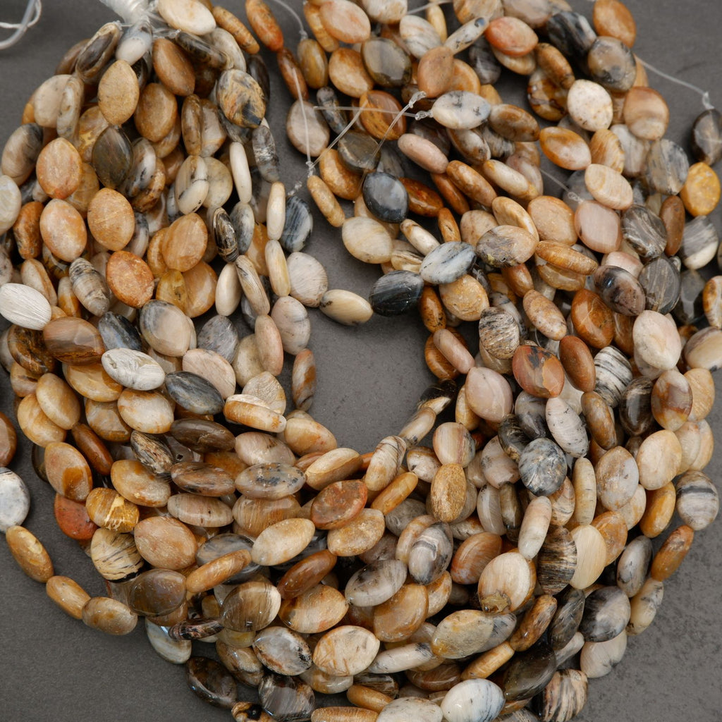 Macro image of marquise-shaped gemstone beads highlighting smooth finish and natural texture.