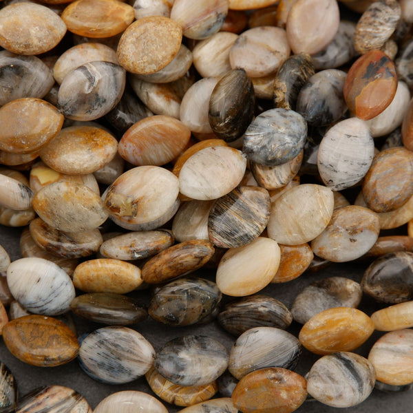 Polished marquise oval natural stone beads in warm earth tones on a dark background.