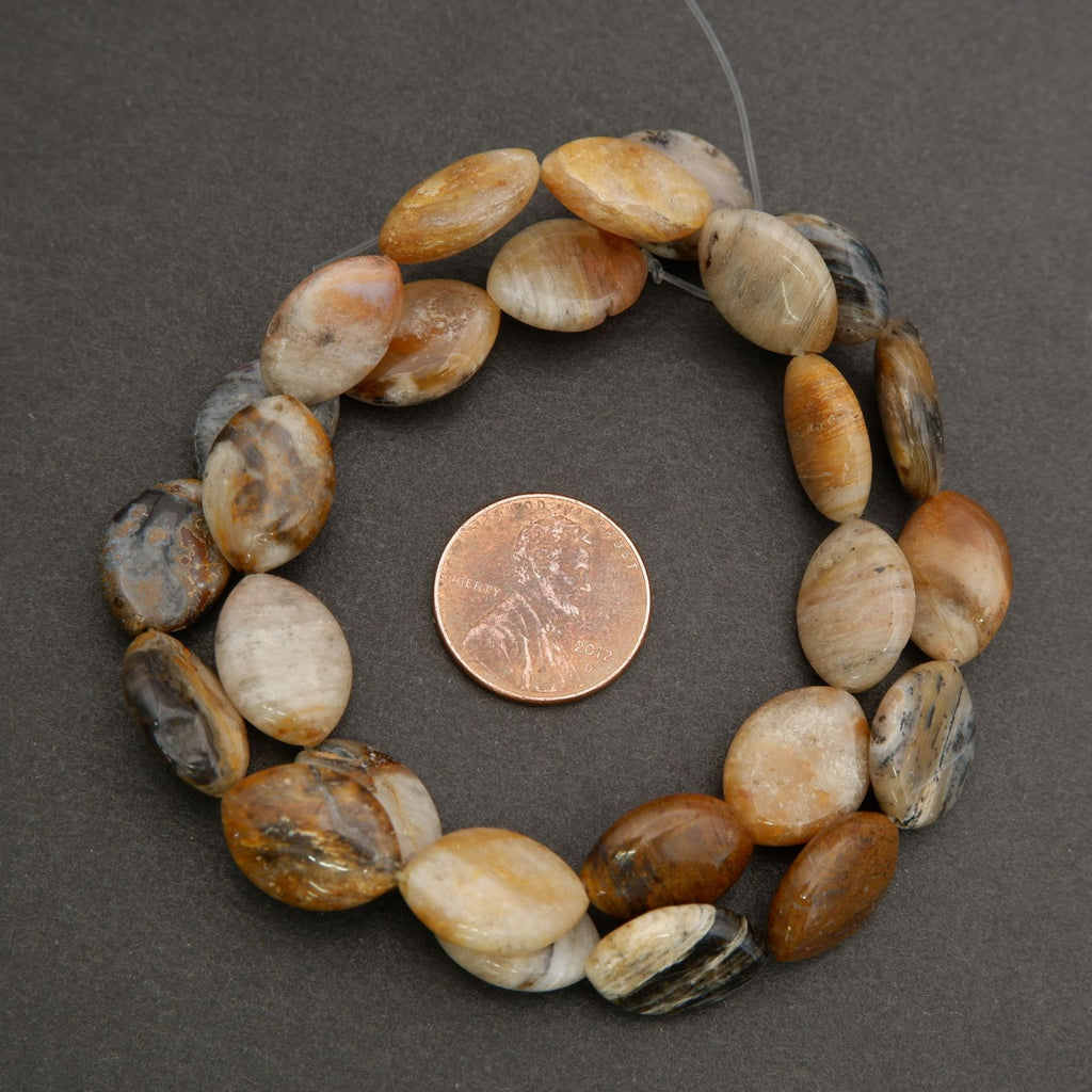 Natural stone marquise oval bead strand featuring earthy color variation and polished surfaces.