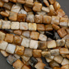 Detailed view of polished stone beads showing natural banding and texture in beige, caramel, and brown colors.