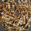 Assorted natural stone bead strands with square and rounded shapes displayed in warm neutral tones.