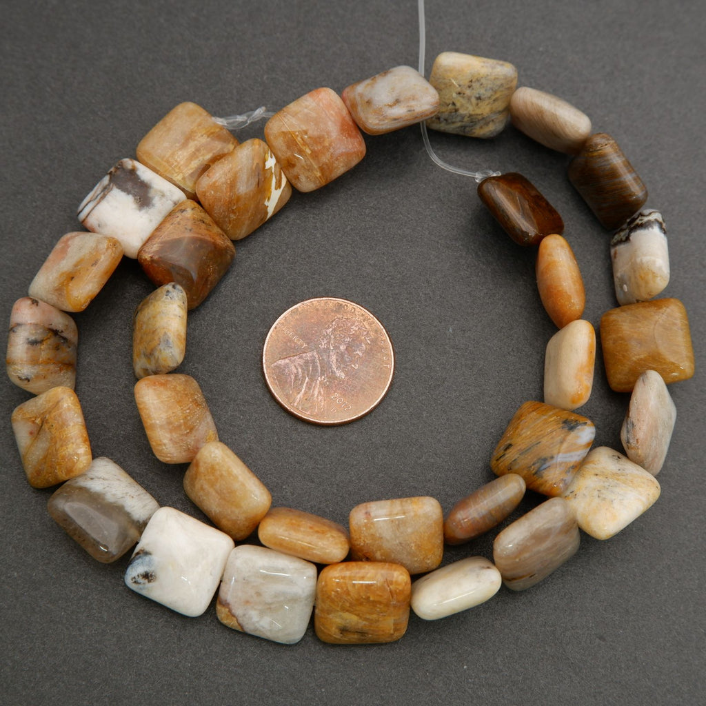 Macro image of polished gemstone beads highlighting natural patterns, color variation, and smooth glossy finish.