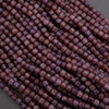 Close-up of purple beads on a gray background