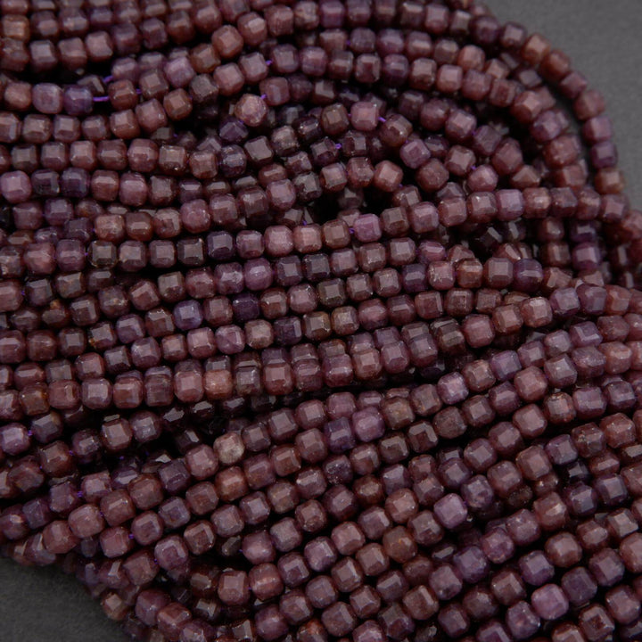 Close-up of a string of purple beads on a gray background
